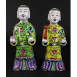 A pair of Chinese famille rose figures of boys, late 19th/20th century,