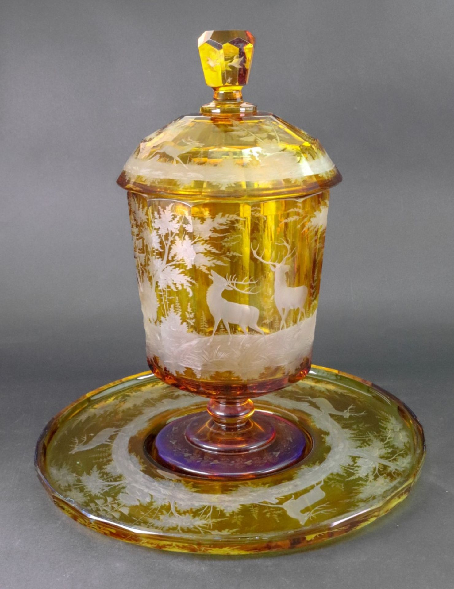 A Bohemian amber-stained glass punch bowl, cover and stand, mid 19th century, the domed cover,