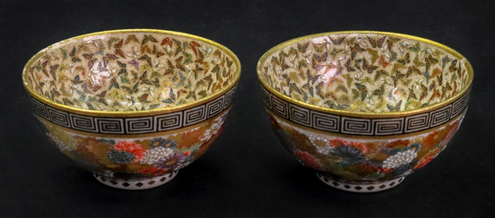 Yabu Meizan; a pair of miniature Japanese Satsuma bowls, painted with butterflies and flowers,