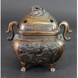 A Chinese or Japanese bronze two handled censer and cover, circa 1900, of rounded square form,