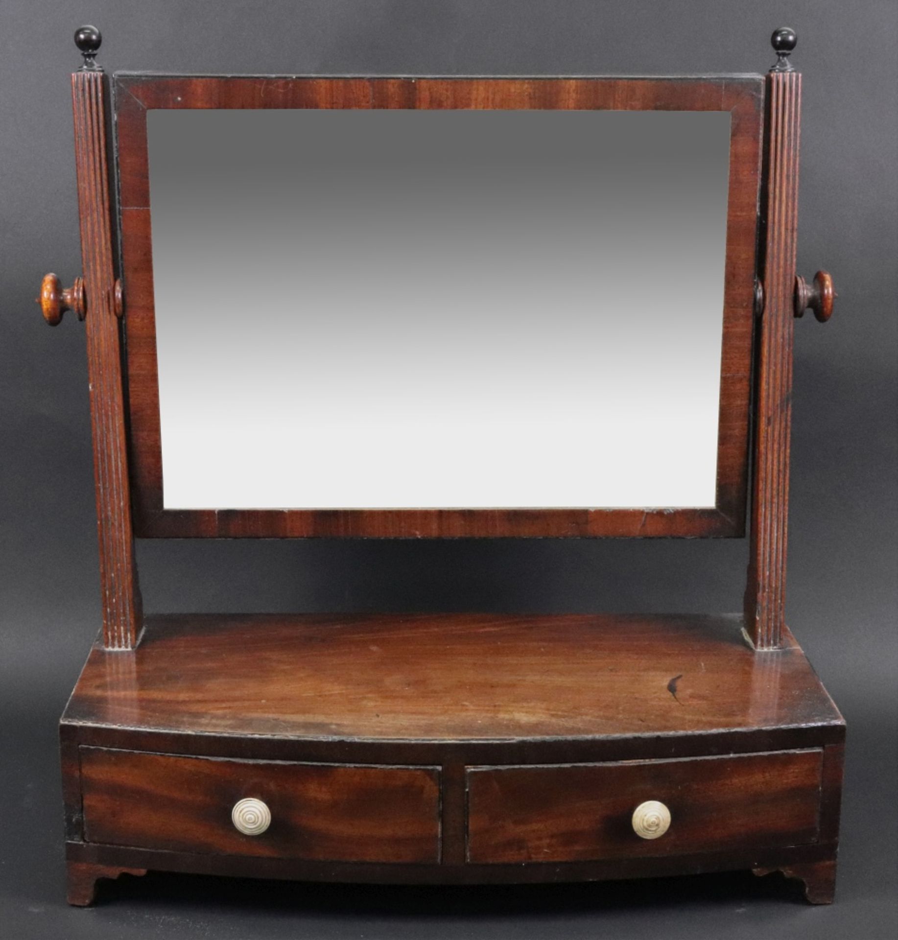 A George III mahogany swing toilet mirror, with ebony banded bowfronted two drawer box plateau base,