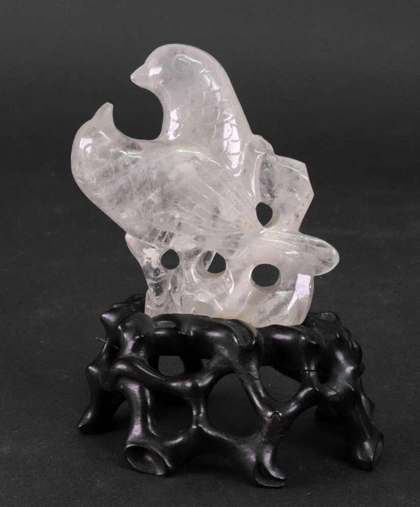 A Chinese rock crystal group of two birds, late 19th/20th century, 9cm high, wood stand.