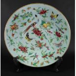 A large Chinese celadon ground famille rose dish, 19th century, brightly enamelled with birds,