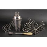 An Art Deco electroplate cocktail shaker, 21cm high, two pairs of Art Deco five bar toast racks,