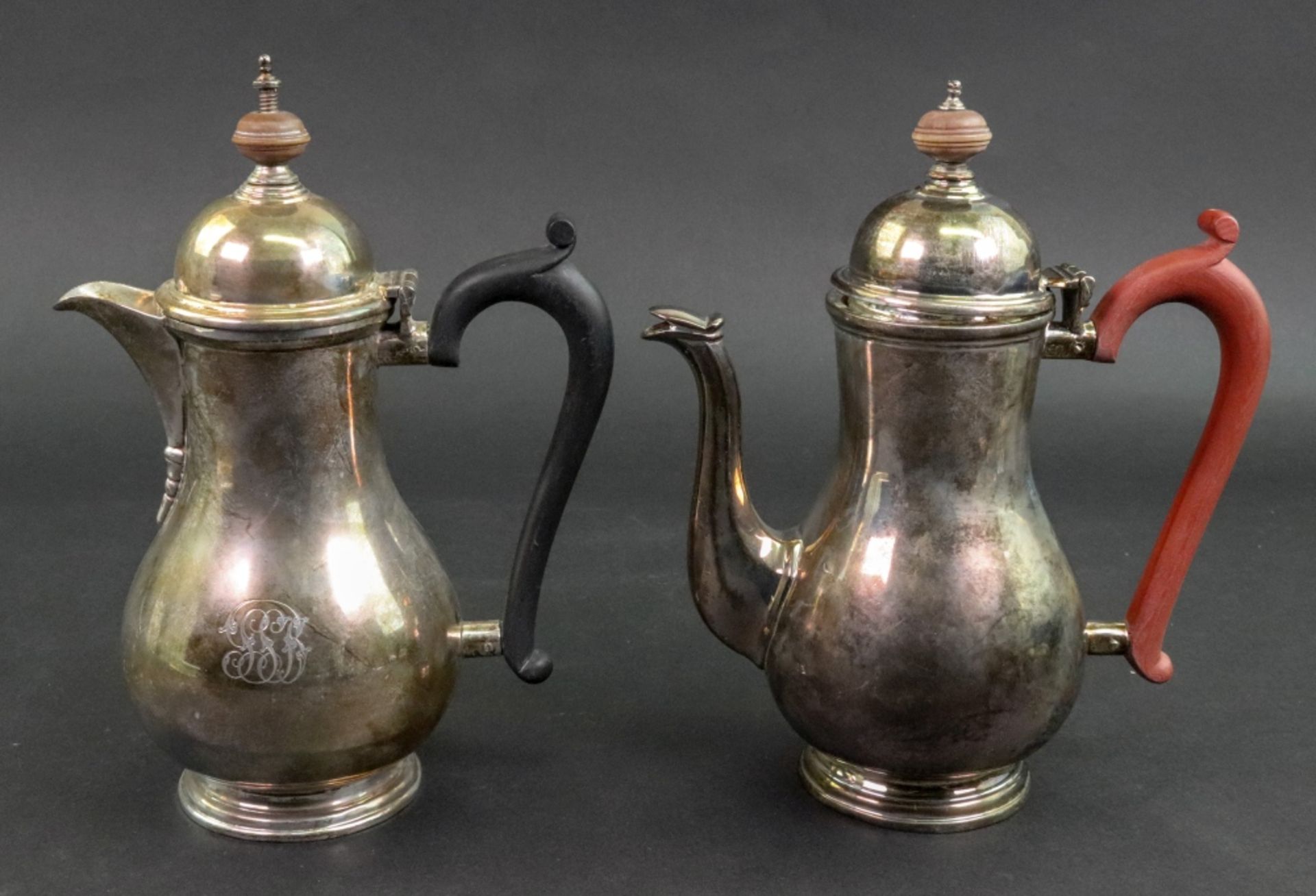 A pair of Queen Anne style pear shape silver cafe au lait pots, Goldsmiths & Silversmiths Company,