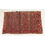 An Afghan rug, with repeated octagons on a rust field, 130 x 82cm and an Afghan rug,