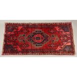 A Hamadan rug, with a central stepped medallion, on a red field, 206 x 102cm and a Kelim bag face,