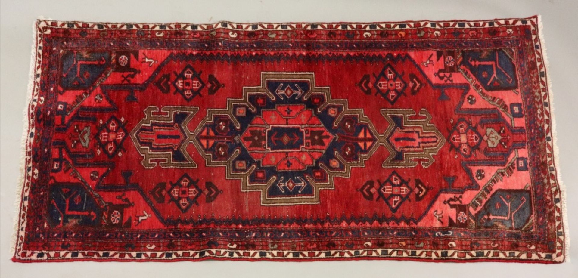 A Hamadan rug, with a central stepped medallion, on a red field, 206 x 102cm and a Kelim bag face,