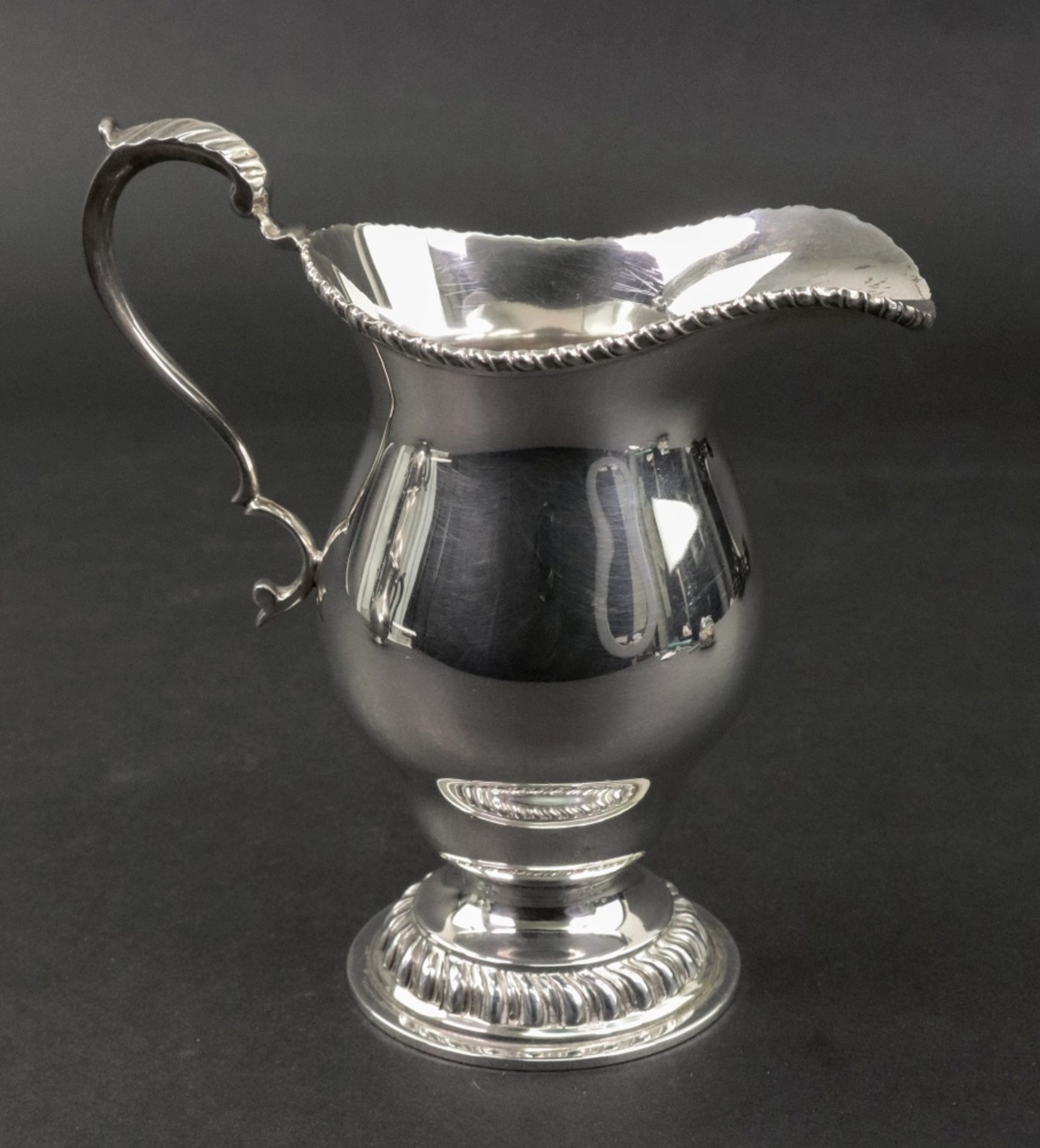 A large George III style silver ogee shape cream jug, London 1973, makers mark B.S.