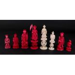 A group of eight Chinese carved ivory chess pieces, 19th century, six stained red and two natural,