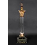 A George III style gilt metal mounted glass corinthian column glass table lamp, circa 1900,