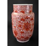 A Chinese porcelain vase, 19th century, of cylindrical form, painted in iron-red with lotus flowers,