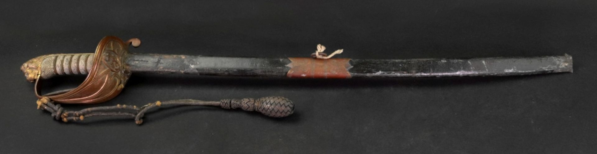 A naval officers sword, with wirebound fishskin grip, lion head pommel and bullion knot,