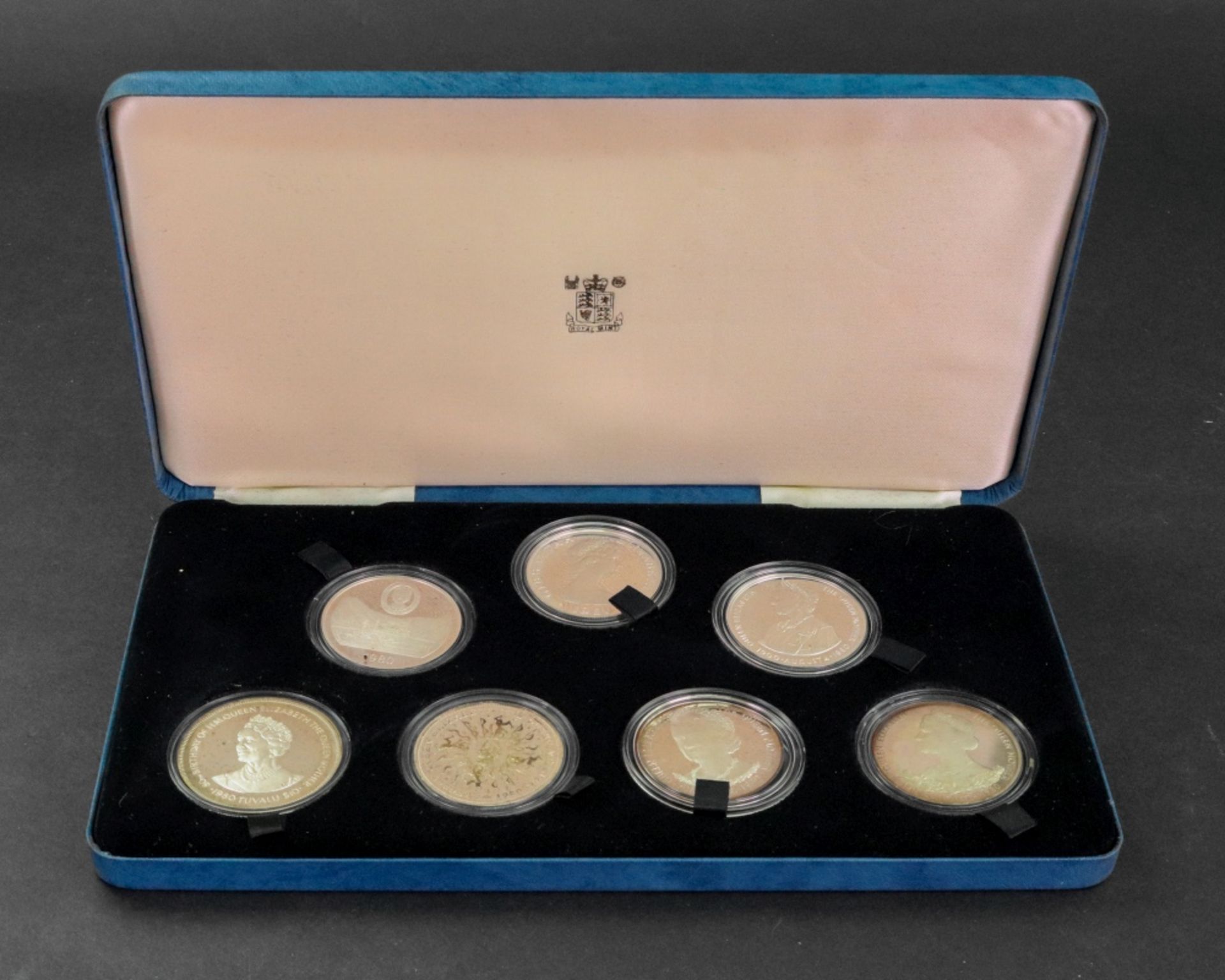 1980 Queen Mother set of seven commemorative silver crowns, cased. - Image 2 of 2