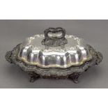 An Old Sheffield plate two handled entree dish, of lobed oval form, with hot water heater base,