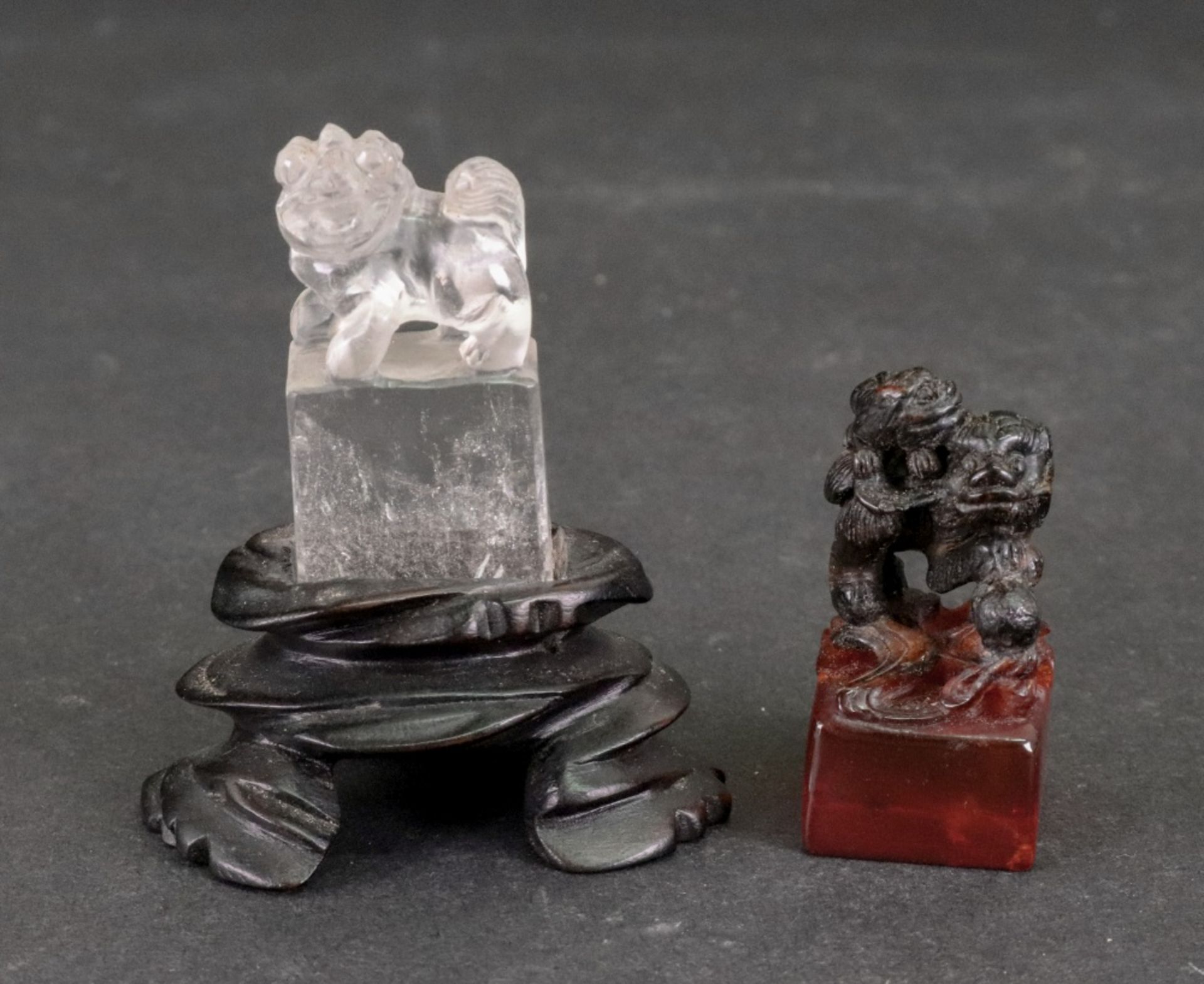 A small Chinese rock crystal carving of a Buddhist lion, standing on a rectangular plinth, 4.