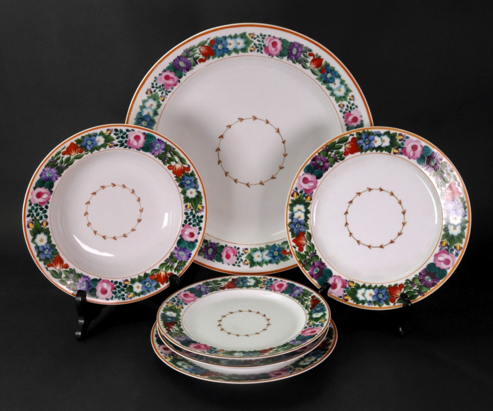 A large Russian circular bowl, a smaller bowl and four plates,