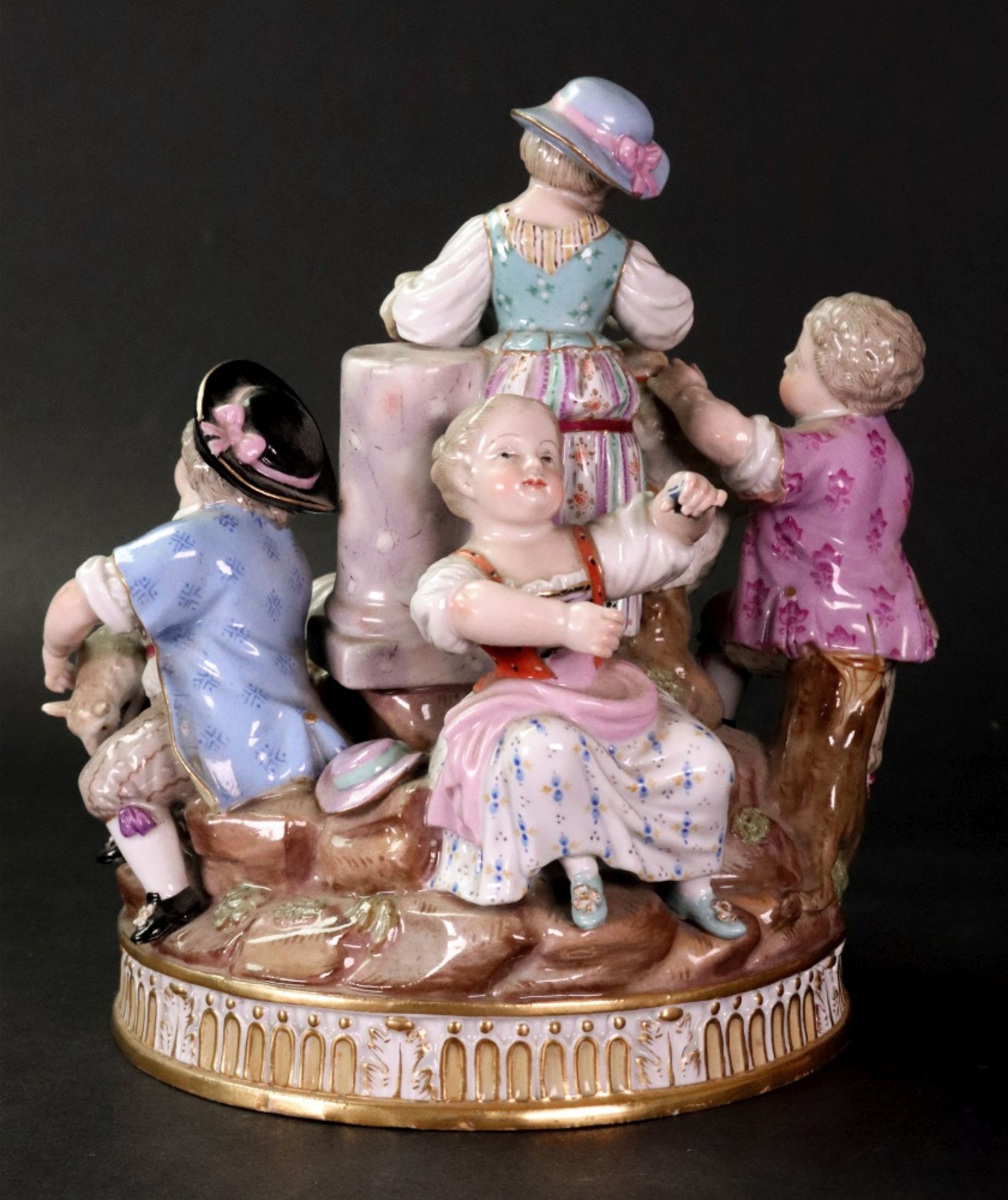 A Meissen group of five children gathered around a rocky mound with a classical column, - Bild 3 aus 8