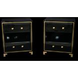 A pair of modern black lacquer two drawer side cabinets with brass inlaid decoration and brass feet,