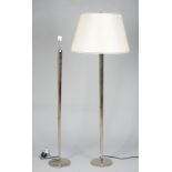 A pair of modern chrome octagonal standard lamps of tapering form on circular plinth bases,