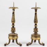 A pair of modern gilt and patinated metal altar candlesticks with acanthus moulded decoration over