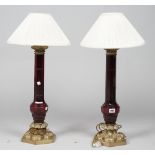 A pair of modern ruby glass and gilt metal table lamps, each of Victorian style on a hexagonal base,