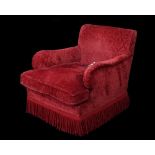 A modern Howard style armchair with red floral upholstery on block supports, 76cm wide x 79cm high.