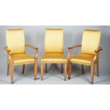 Linley; a set of twelve gold silk upholstered walnut dining chairs on silver plated capped supports,