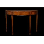 A George III style inlaid mahogany demi-lune console table on tapering square supports,