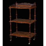 A Victorian walnut three tier serpentine what-not with galleried top, 55cm wide x 91cm high.