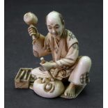 A Japanese ivory okimono of a craftsman,