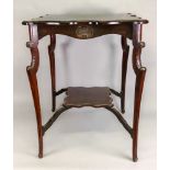 An Edwardian carved mahogany two tier window table, on cabriole legs,