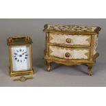 A French brass carriage timepiece, with key, and a miniature Florentine two drawer commode (3).