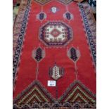 A mid 20th century Persian rug on burnt amber field and in good condition (260 cm x 152 cm approx)