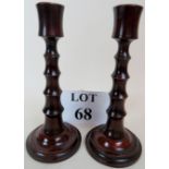 A pair of Edwardian turned fruit-wood candlesticks, with original brass liners,