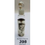 A small glass scent bottle in silver case, embossed with cherub,