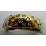 An 18ct gold ring inset with small wide diamonds, size O,