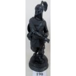 A bronzed metal statue depicting an ancient warrior,