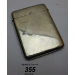 A plain silver card case, approx 2.