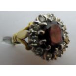 A diamond and garnet cluster ring, size M,