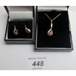 A 9ct gold ruby and diamond pendant on a fine chain,