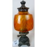 A large and decorative cast metal table lamp with coloured glass shade,