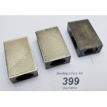 A set of three Asprey's matching silver matchbox holder with engine turned decoration,