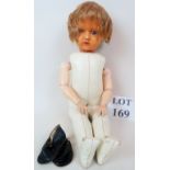 A vintage plastic head doll with blue sleeping eyes,