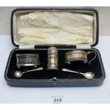 A complete 3 piece silver condiment set and matching spoons,