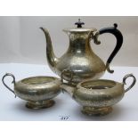 A three piece silver engraved coffee set, comprising of coffee pot, sugar and cream jug,