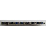 A diamond bar brooch, set with ten diamonds, four sapphires and five blue coloured stones,
