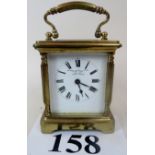 An early 20th century brass carriage clock, dial inscribed 'Coombes Company Limited, Watch Makers,