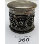 An embossed silver box with angel decoration,