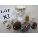 Five decorative porcelain thimbles, a Cloisonné enamel thimble, a serpentine stone egg,